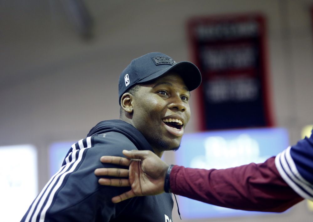 Guerschon Yabusele is greeted by players while watching a Maine Red Claws game March 23 at the Portland Expo. Yabusele, a native of France, has obtained a visa and will play able to play for the Red Claws as soon as Friday. (Staff photo by Derek Davis/Staff Photographer)