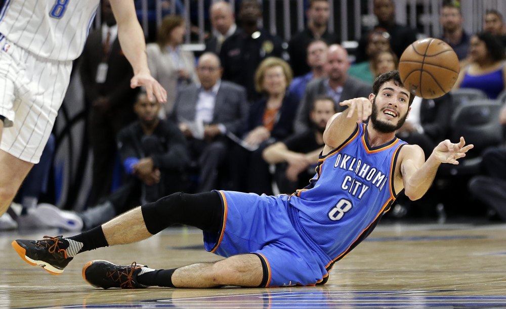 Oklahoma City's Alex Abrines makes a pass after scooping up a loose ball during the first half of the Thunder's game against the Magic on Wednesday night in Orlando, Florida. The Thunder rallied for an OT win.