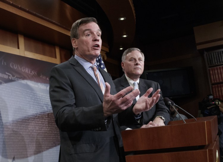 Senate Intelligence Committee Vice Chairman Sen. Mark Warner, D-Va., left, with Committee Chairman Sen. Richard Burr, R-N.C., speaks during a news conference on Capitol Hill in Washington, to discuss their panel's investigation of Russian interference in the 2016 election.
