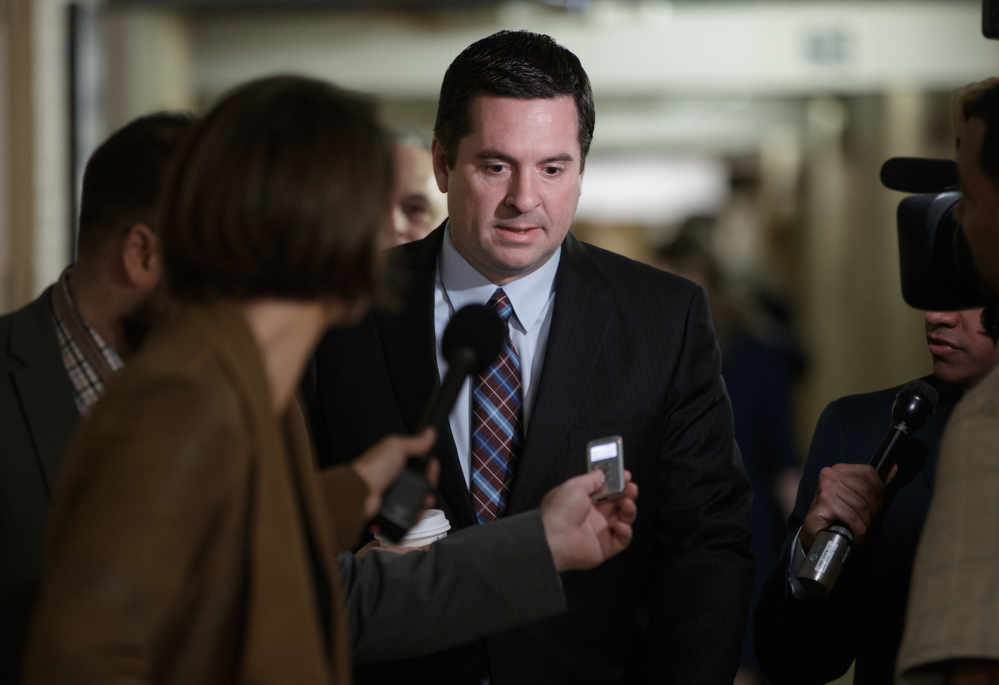 House Intelligence Committee Chairman Devin Nunes, R-Calif. is pursued by reporters as he arrives for a weekly meeting of the Republican Conference on Tuesday. Nunes faces growing calls to step away from the panel's Russia investigation as revelations about his secret source meeting on White House grounds raise questions about his independence.