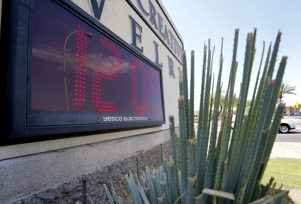 A sign in direct sunlight indicates 120 degrees in Phoenix in 2016. Phoenix is one of many U.S. cities facing what seems to be the inevitable reality of a hotter and drier future. Public health and economic prosperity are both at risk