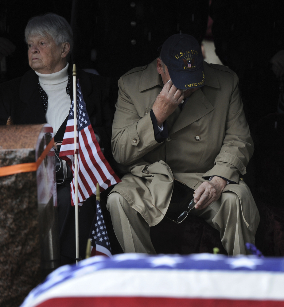 Relative Robert Whelihan wipes away a tear during the graveside service for Army Cpl. Jules Hauterman Jr., who was laid to rest in Holyoke, Mass., on Friday.