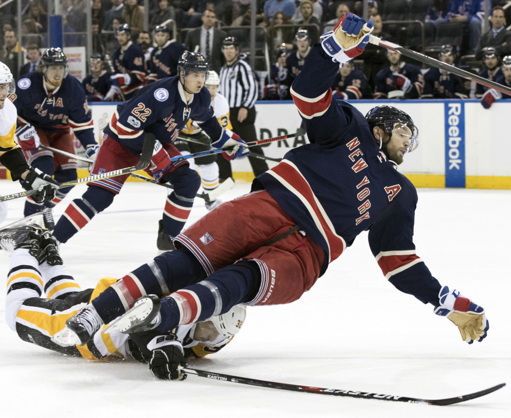 Pittsburgh defenseman Mark Streit, bottom, trips New York Rangers right wing Rick Nash during the second period of the Penguins' 4-3 win in overtime at New York.