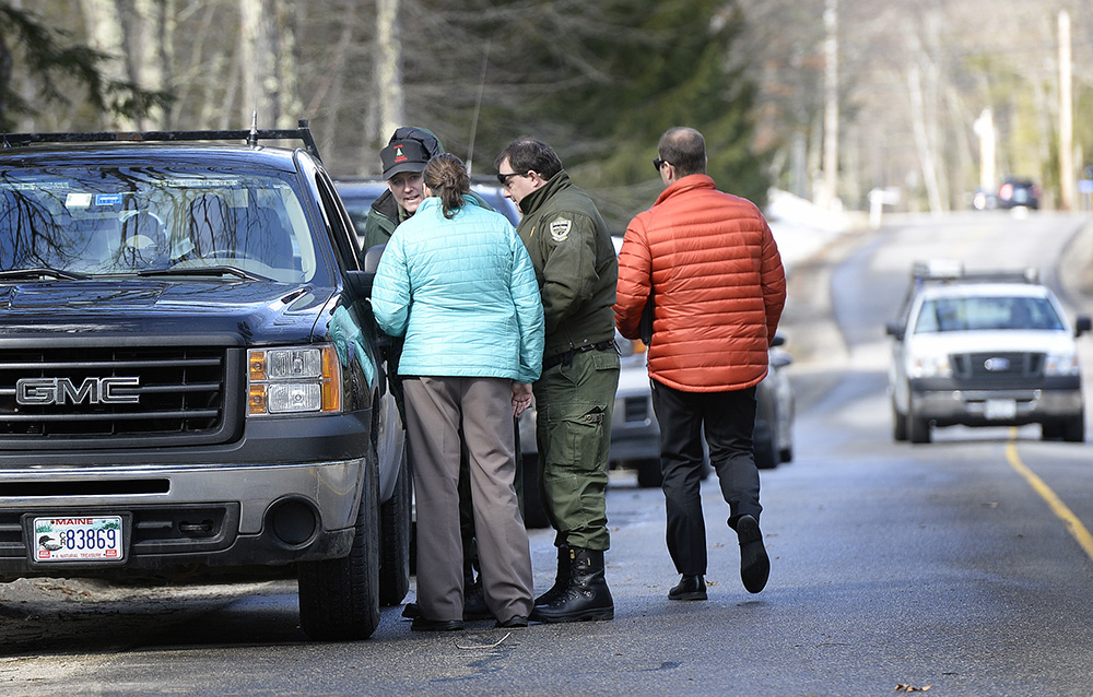 Detectives and game wardens talk Thursday at the scene in Arundel where Maine State Police are investigating the death of 63-year-old Matthew Coito, which they characterized as suspicious. 