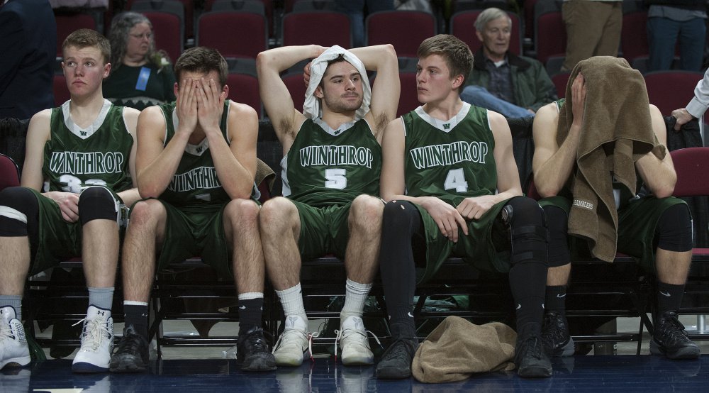MARCH 4: Members of the Winthrop boys basketball team react after George Stevens Academy won the Class C state title at the Cross Insurance Center in Bangor.