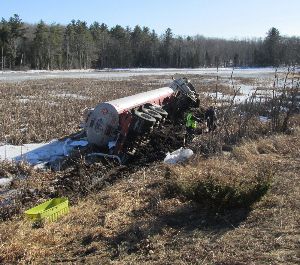 A Maine State Police photo shows an overturned oil tanker truck that collided with a car on Route 3 in Liberty on Monday.