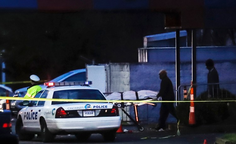 A body is removed as police work at the Cameo club after a fatal shooting on Sunday in Cincinnati. 