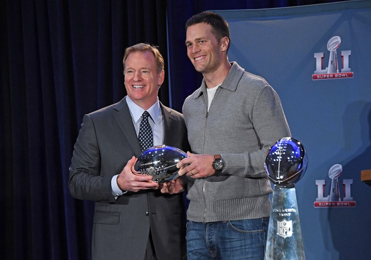 NFL commissioner Roger Goodell presents Patriots quarterback Tom Brady with the Pete Rozelle Trophy as Super Bowl LI's most valuable player on Feb 6, 2017, in Houston.