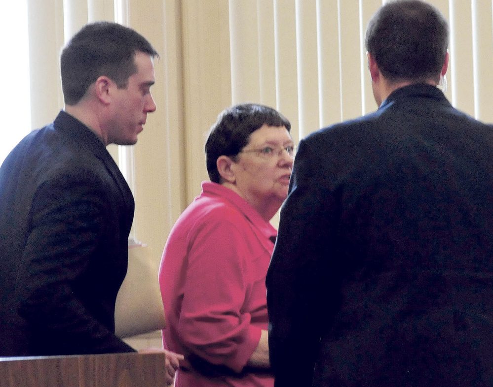 Mary O'Donal and her attorney Christopher Berryment, left, speak with a court officer after O'Donal was sentenced Thursday in Franklin County Superior Court to three years in prison, with all but 30 days suspended, and ordered to pay restitution for stealing more than $300,000 from the Share and Care Food Closet in Farmington. 