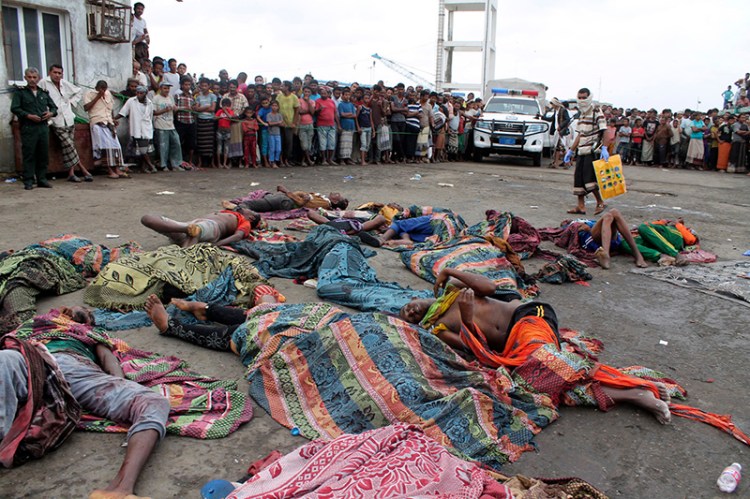 Bodies of Somali migrants, killed in attack by a helicopter while traveling in a boat off the coast of Yemen, lie on the ground at Hodeida, Yemen on Friday.