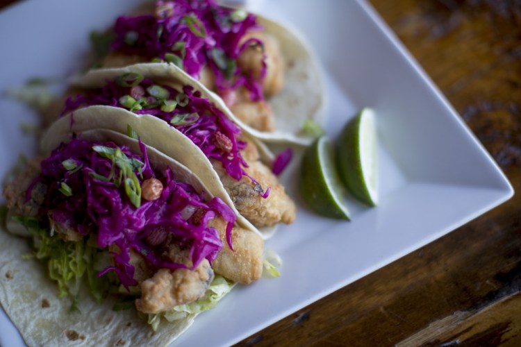Rice-flour-battered local pollock fish tacos with cabbage and golden raisin slaw and kimchi remoulade.
