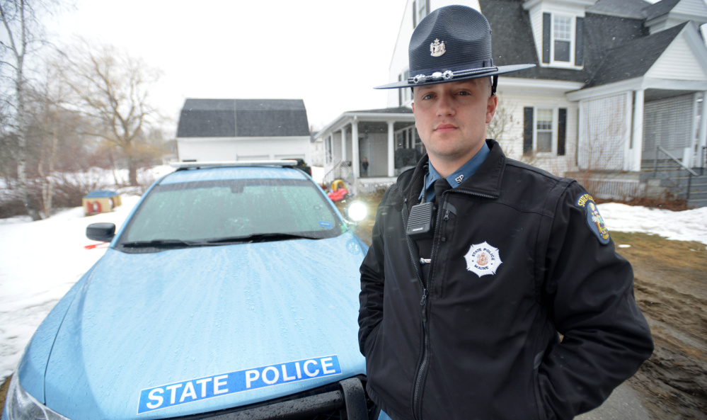 Trooper Tyler Maloon stands in front of his police cruiser Saturday at his home in Pittsfield. After Maloon responded to a report of a car-versus-deer accident early Saturday morning in Fairfield, he found that the car's occupants were carrying prestigious cargo – the Vince Lombardi Trophy. The couple in the car had been taking it to the Cross Insurance Center in Bangor for viewing.