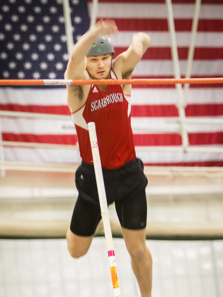 Scarborough's Sam Rusak clears the bar at 16 feet, 3 inches to set a pole vault state record at the Class A indoor track championships. Rusak also won the high jump and 200 meters as he swept all three of his events for the second straight year.