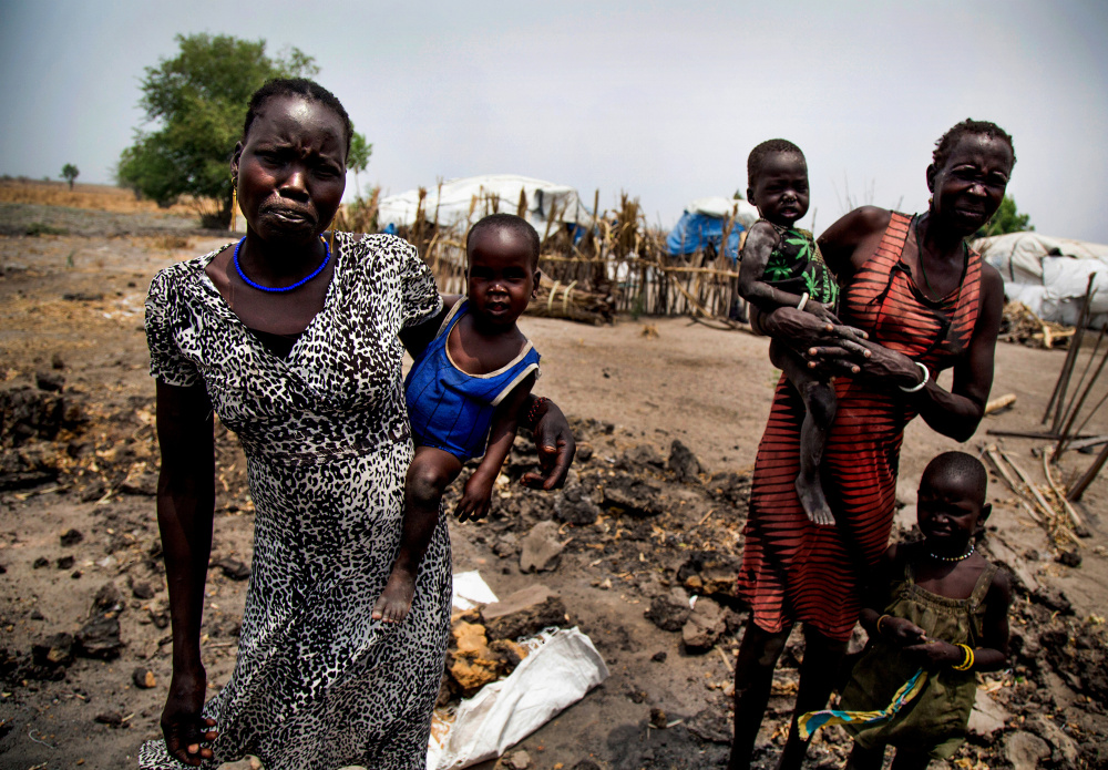 In 2013, a clash between the South Sudan president and vice president became a broader ethnic conflict that's left Nyakuma Tap, left, and her older sister Nyakuoth Kuol homeless and hungry after their house was destroyed.