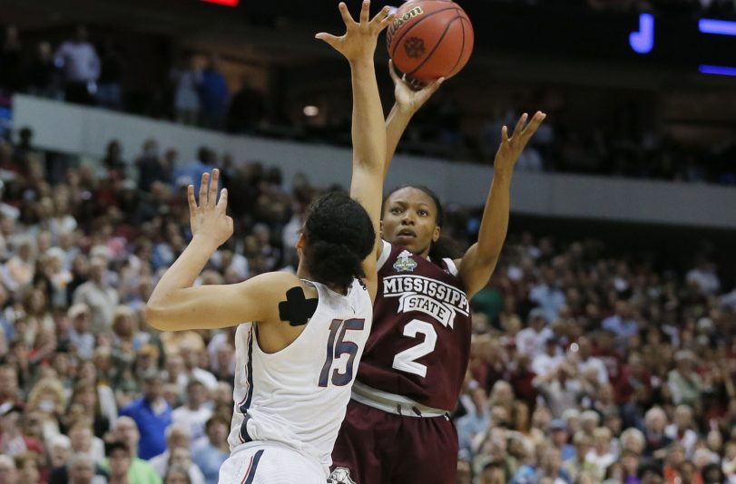 Mississippi State's Morgan William shoots over UConn's Gabby Williams as time expires in overtime to give the Bulldogs a 66-64 win Friday in the Final Four. The loss ended the Huskies' 111-game winning streak.