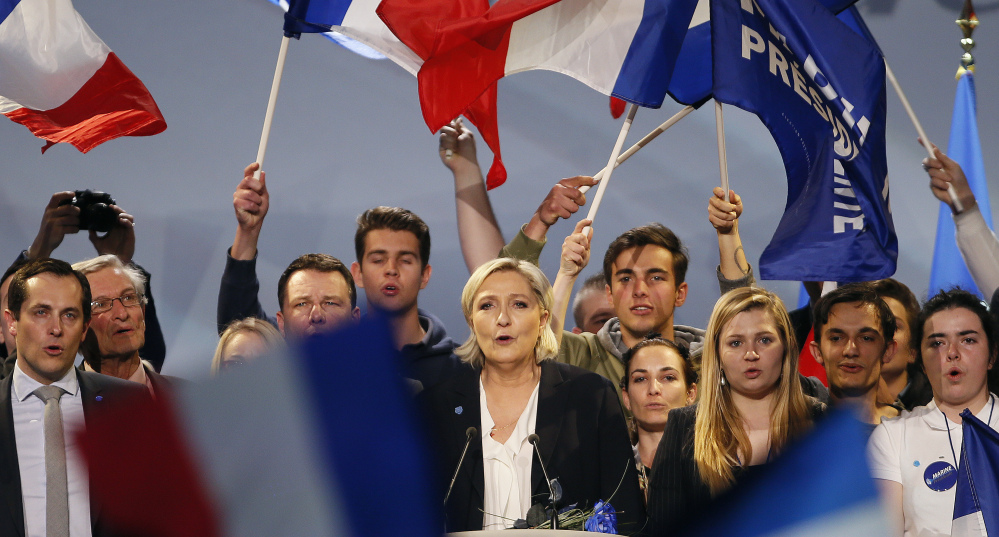 Marine Le Pen, a far-right presidential candidate in France, and her supporters sing after her speech Sunday in Bordeaux. Le Pen was the first foreign politician to congratulate Donald Trump after he was elected, but she now barely mentions his name in a country where nearly 8 in 10 voters strongly dislike the U.S. president.