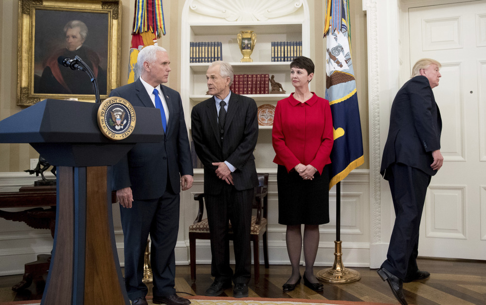 President Trump leaves after speaking but before signing executive orders regarding trade in the Oval Office at the White House on Friday. Also pictured, from left, are Vice President Mike Pence and National Trade Council adviser Peter Navarro.