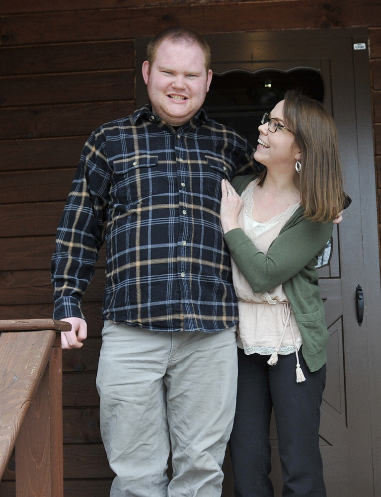 Kelsey Dunn, 28, of Brunswick and her brother Silas Gingrow, 20, who has intellectual disabilities, stand outside Gingrow's group home in Bath.