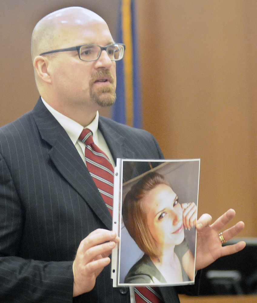 Assistant Attorney General Donald Macomber holds a photo of victim Jillian T. Jones during opening arguments last year in the murder trial of Justin Pillsbury.