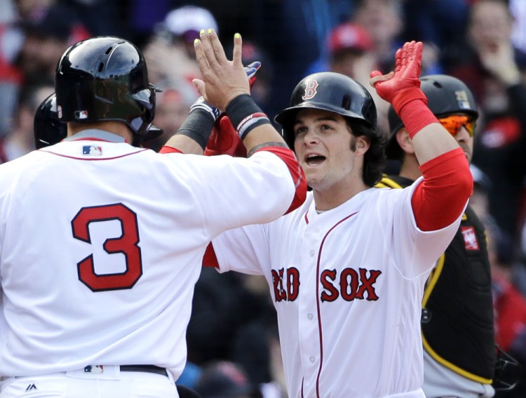 Andrew Benintendi celebrates his three-run homer with Red Sox teammate Sandy Leon in the fifth inning Monday against the Pittsburgh Pirates at Fenway Park. The homer capped a five-run inning, and the Red Sox held on for a 5-3 win in their season opener. (Associated Press/Elise Amendola)