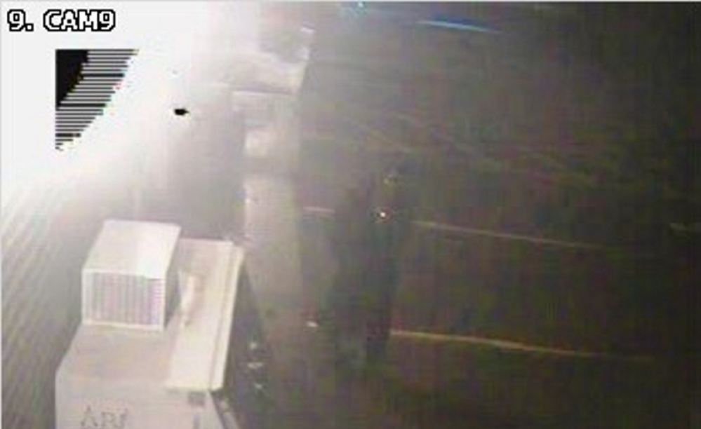 A surveillance photo from Annie's Market in Sidney shows the suspect police believe damaged the convenience store early Sunday. The suspect was described as a man who was wearing jeans, a skull face mask and a dark trench coat.