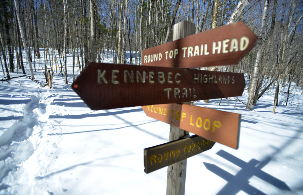 Trail signage marks the beginning of the Round Top Mountain trail in Rome on March 17, the day after game wardens found the body of Brian Peters on the mountain trail. Officials initially thought he had died of cold weather exposure, but the medical examiner says he died from cardiac arrest.