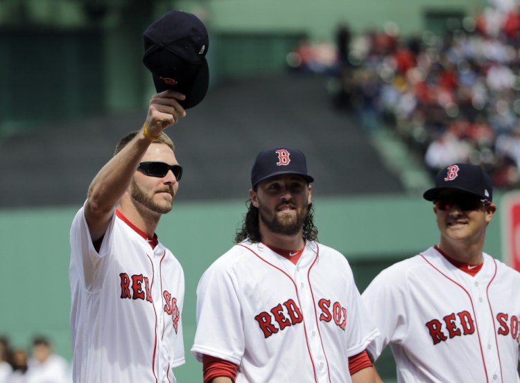Boston Red Sox pitcher Chris Sale lifts his cap to cheering fans during Red Sox Home Opening Day ceremonies at Fenway Park on Monday.