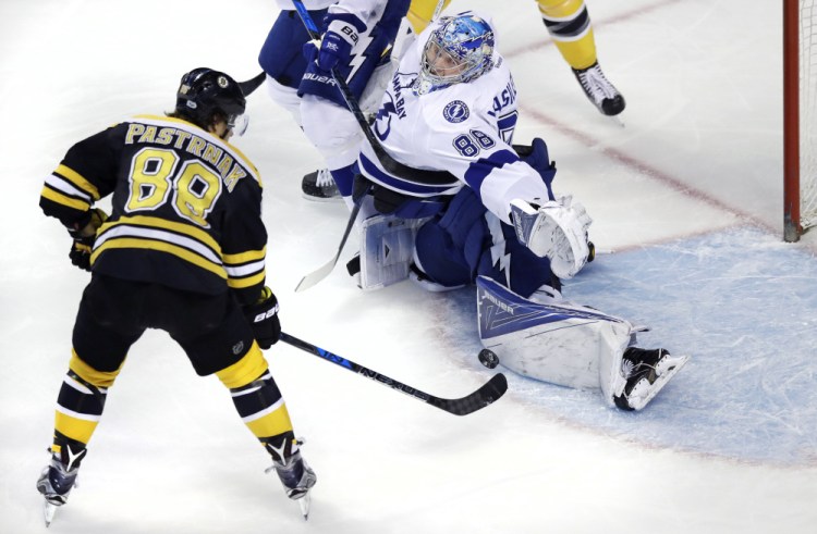 Tampa Bay Lightning goalie Andrei Vasilevskiy, right, makes a save on a shot by Boston Bruins right wing David Pastrnak during the Bruins' 4-0 win Tuesday in Boston.
