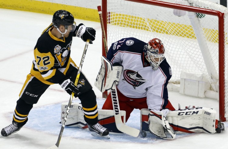 Blue Jackets goalie Sergei Bobrovsky gathers a rebound before Pittsburgh's Patric Hornqvist can get his stick on it during the first period of Tuesday's game at Pittsburgh.
