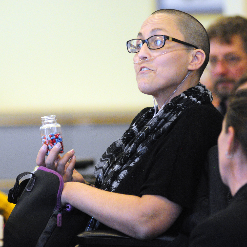 Stephanie Packer, who is terminally ill, holds pills that she said were prescribed to her as an option for ending her life under California's "death-with-dignity" law. Packer, who opposes such laws, said her health insurer would pay for the pills but not for chemother- apy.
