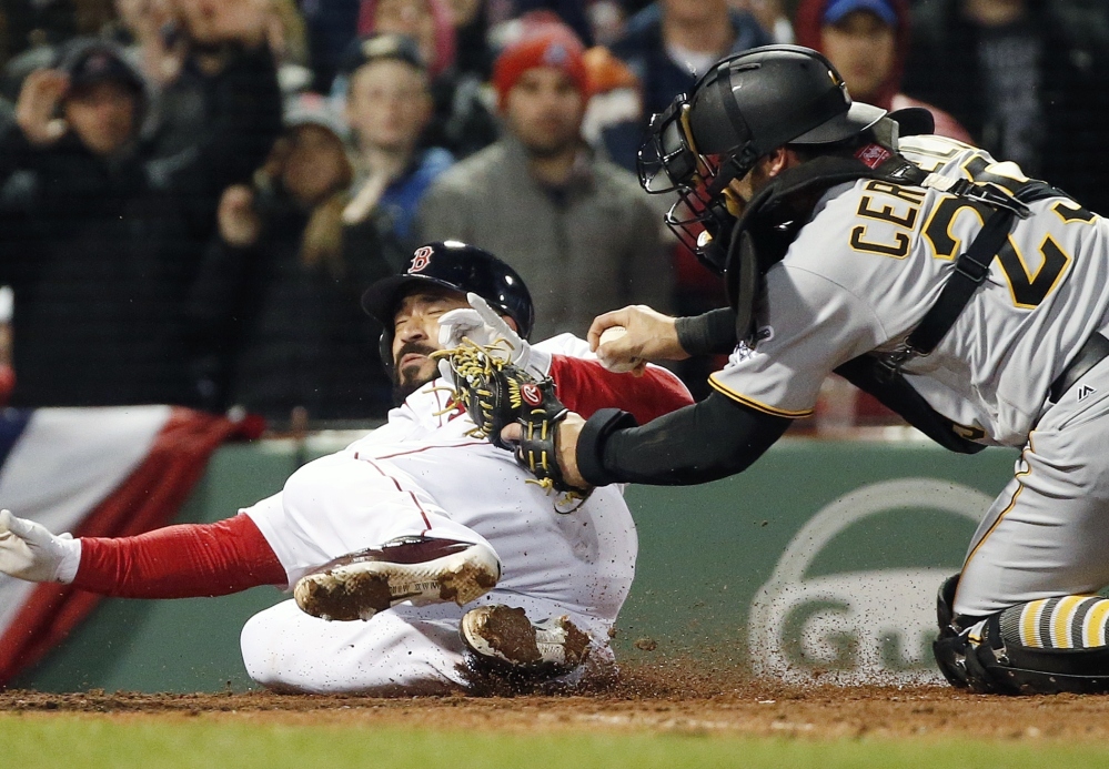 Boston's Sandy Leon, left, is tagged out at home by Pirates catcher Francisco Cervelli on a single by Dustin Pedroia in the third inning of a Wednesday night's game at Boston.