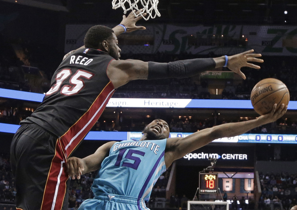 Kemba Walker of the Charlotte Hornets attempts to get a shot over Willie Reed of the Miami Heat during the second half of Miami's 112-99 victory Wednesday night. The Heat are tied for eighth in the East.