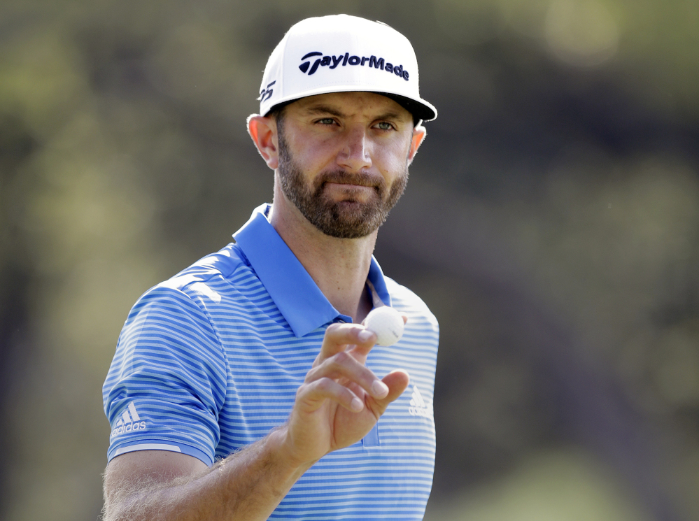 Dustin Johnson, in this March 26, waves to the gallery at Austin County Club in Austin, Texas. On Thursday, Johnson withdrew from the Masters with a back injury. (Associated Press/Eric Gay)