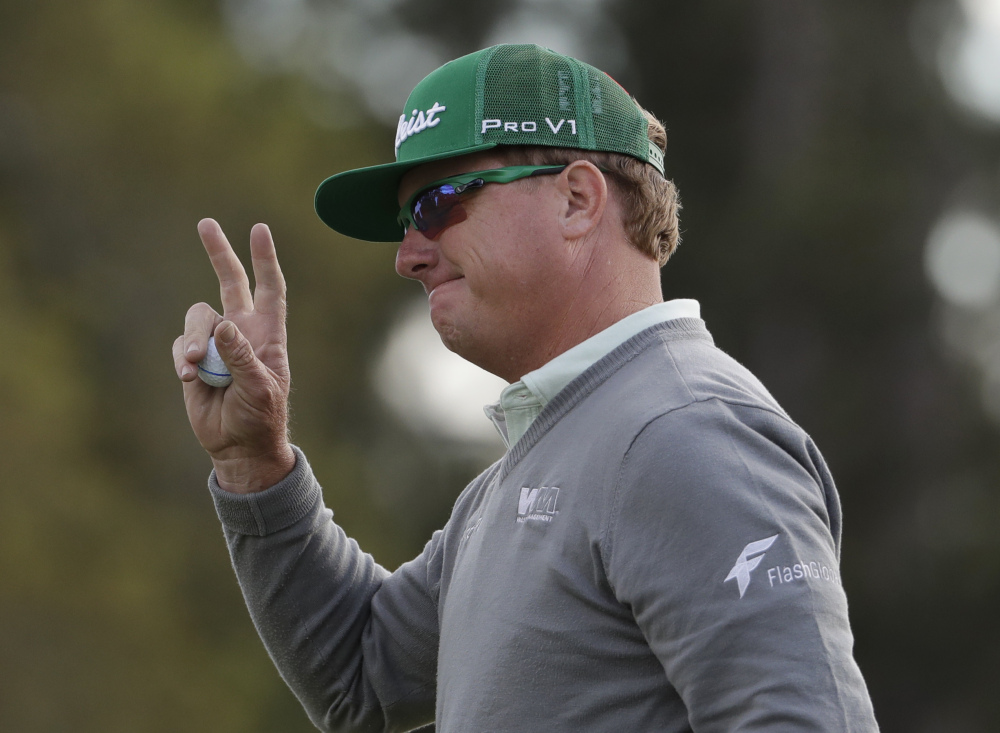 Charley Hoffman waves to the crowd after finishing his 7-under 65 in the first round of the Masters on Thursday in Augusta, Ga. Only one other player, William McGirt (69), broke 70 in windy conditions.
