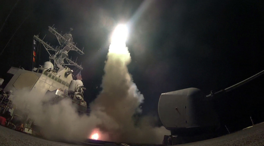 The guided-missile destroyer USS Porter launches a Tomahawk missile early Friday, one of 59 targeting a Syrian air base where Monday's chemical weapons attack on civilians was launched.