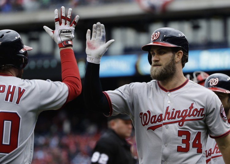 Washington's Bryce Harper, right, celebrates with Daniel Murphy after hitting a two-run homer in the first inning of a 7-6 win against the Phillies on Friday at Philadelphia.