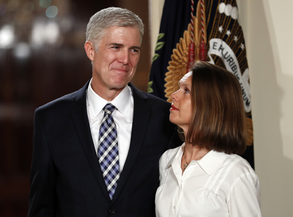 Critics wonder whether there is an independent streak inside new Justice Neil Gorsuch, seen here with his wife, Marie Louise, when President Trump announced his appointment.