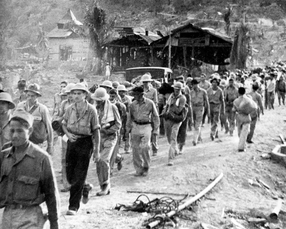 American and Filipino prisoners of war captured by the Japanese are shown at the start of the Death March after the surrender of Bataan in the Philippines during World War II.
