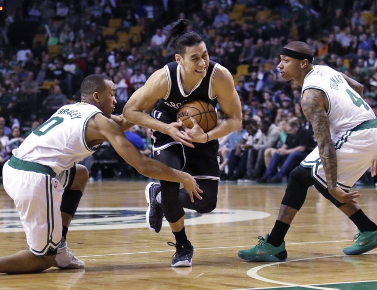 Brooklyn's Jeremy Lin drives between Avery Bradley, left, and Isaiah Thomas of the Celtics during Monday's game at TD Garden. Lin scored 26 points, but Boston won, 114-105.
Associated Press/Charles Krupa