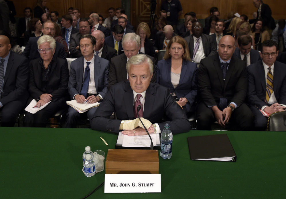 Wells Fargo's then-CEO John Stumpf testifies before the Senate Banking Committee last September about fake accounts created by bank employees to meet sales goals. Stumpf was an optimist "who refused to believe that the sales model was seriously impaired," a directors' report says.