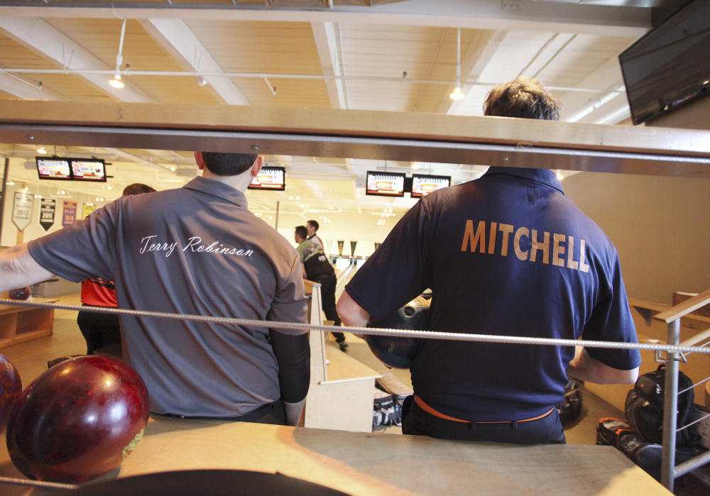 Terry Robinson and Charlie Mitchell watch the bowlers while awaiting their turns in the doubles tournament. Mitchell is a co-owner of the host Bayside Bowl.