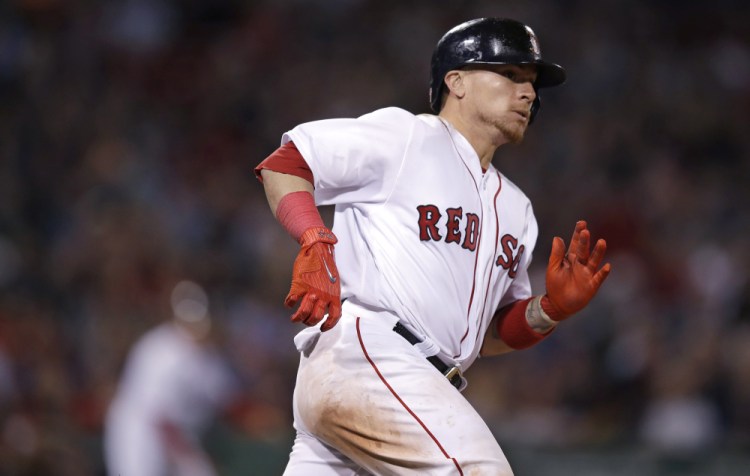 The Red Sox's Christian Vazquez rounds first on a two-RBI triple Tuesday during the eighth inning against the Baltimore Orioles at Fenway Park in Boston.