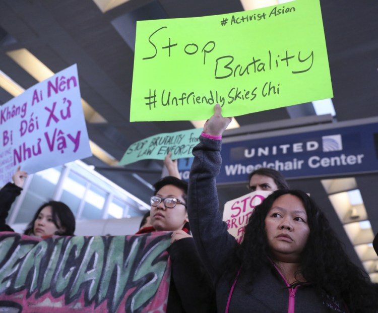 People with Asian community organizations protest after David Dao was removed from a United Airlines airplane by Chicago airport police at O'Hare International Airport.