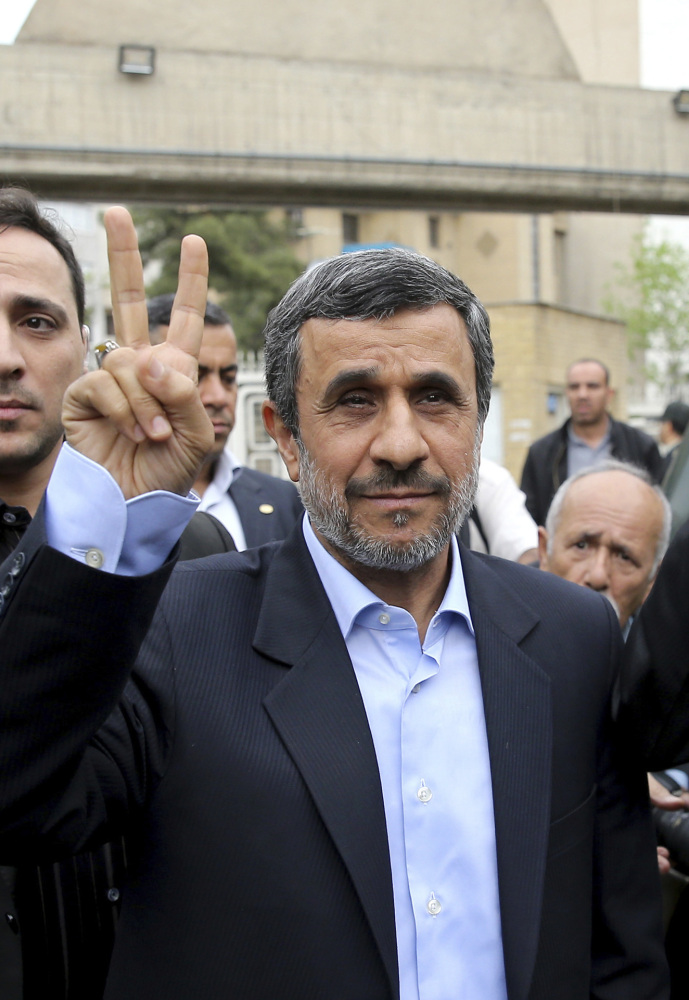 Former Iranian President Mahmoud Ahmadinejad,  flashes a victory sign in Tehran, Iran, on Wednesday.