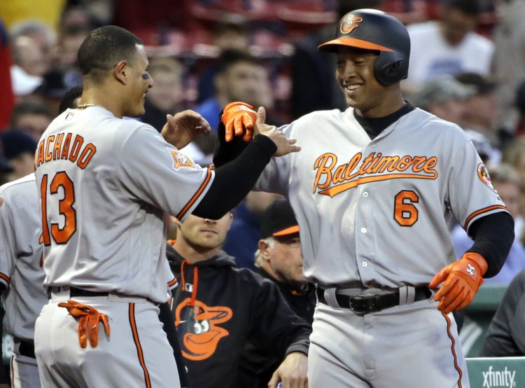 Baltimore's Jonathan Schoop, 6, celebrates his solo home run with Manny Machado in the first inning Wednesday night at Fenway Park.