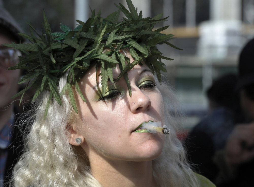 A woman smokes marijuana during a rally to protest for the legalization of marijuana in Toronto in 2012. Marijuana enthusiasts across Canada gather by the thousands every year on April 20 for an international celebration-cum-protest for marijuana legalization.