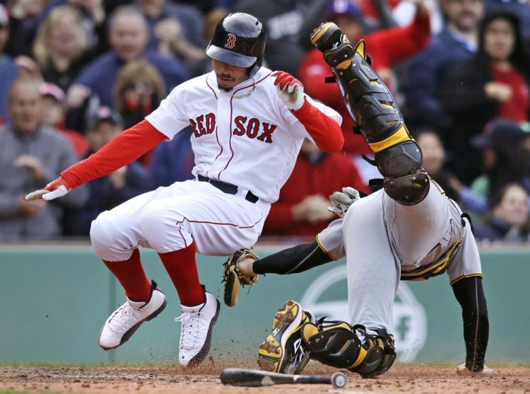 Pittsburgh catcher Chris Stewart, right, tags out Boston's Mookie Betts, who wase trying to score on a hit by Hanley Ramirez during the eighth inning of Thursday's game at Fenway Park in Boston.