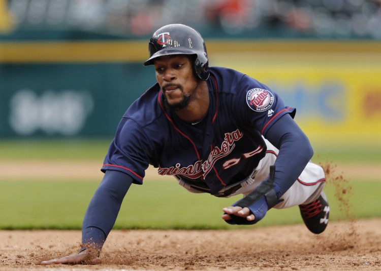 Byron Buxton of the Minnesota Twins dives safely back to first base on an attempted pickoff Thursday during the sixth inning of the 11-5 victory against the Detroit Tigers.