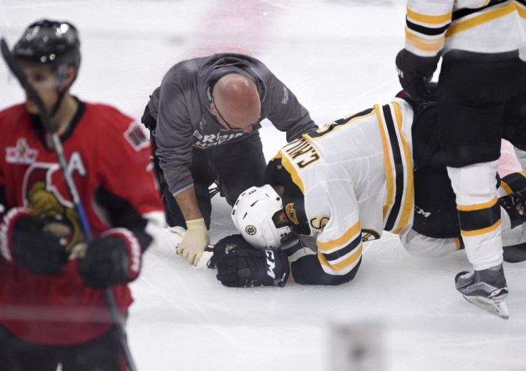 Defenseman Colin Miller left Game 1 of the Bruins' playoff series against Ottawa on Wednesday night after a knee-on-knee check, and his status is uncertain for Game 2 on Saturday.