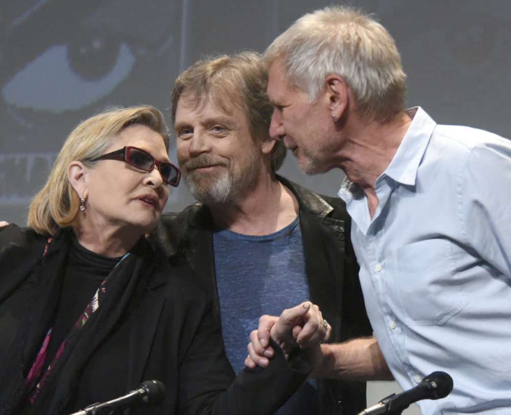 Carrie Fisher, Mark Hamill and Harrison Ford attend Comic-Con International in San Diego in 2015. 
